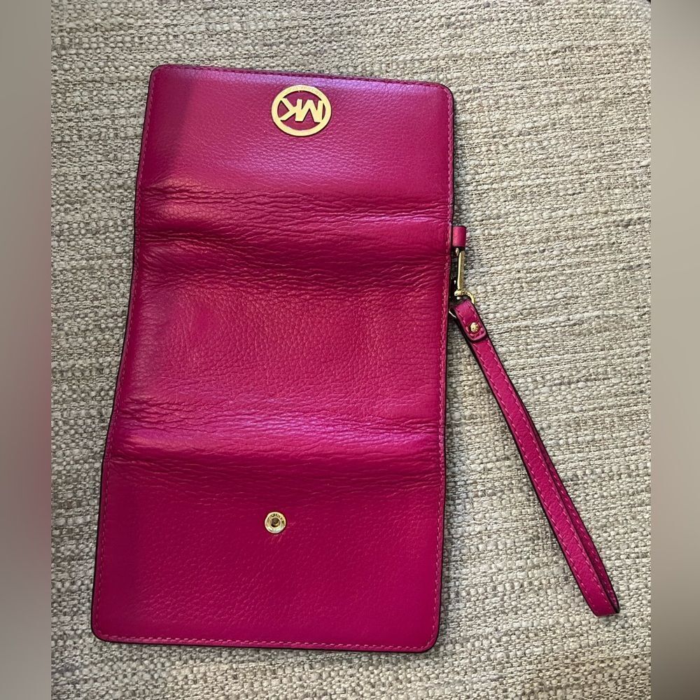 Michael Kors fuchsia multi function wristlet - image 1